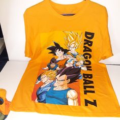 Dragon Ball Z Shirt Xl,Brand New With Tags Yellow Short Sleeve Shirt With Graphic Print, Yellow Short Sleeve Streetwear Shirt, Yellow Cotton Tops With Character Print, Yellow Graphic Tee With Screen Print, Yellow Graphic Tee Shirt With Screen Print, Yellow Short Sleeve Top With Character Print, Yellow T-shirt With Character Print, Yellow Graphic Tee With Character Print, Yellow Short Sleeve Fan Merchandise Top