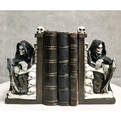 two bookends with skeleton figurines sitting on them