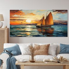 a living room with a couch and painting on the wall above it that has sailboats in the water