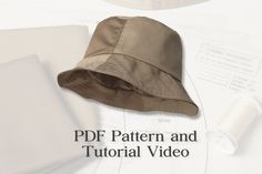 a hat sitting on top of papers next to scissors and sewing thread with the words pddf pattern and tutorial video written below