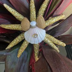 a close up view of a flower with gold glitters on it's petals