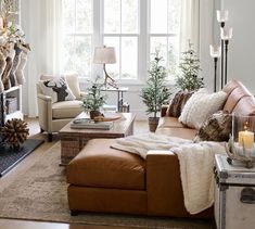 a living room filled with furniture and a fire place in front of a large window