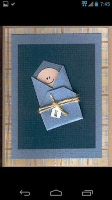 an origami doll in a blue envelope