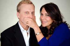 a man and woman are posing for a photo with their hands on their chins