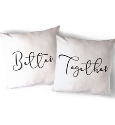 two white pillows with black lettering that say, better together and the words on them