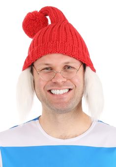 a man wearing a red knitted hat with white fur pom - poms