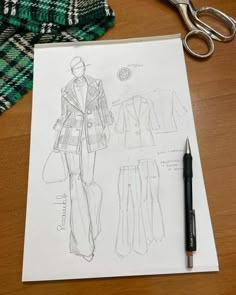 a drawing of a woman's coat and pants next to a pair of scissors