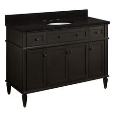 an image of a bathroom vanity with black counter top and drawers on the bottom side