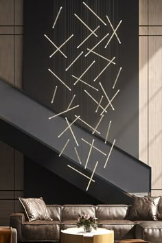 a living room filled with furniture next to a stair case covered in sticks and lights