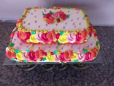 there is a cake that has been decorated with flowers on the top and bottom layer