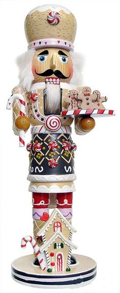 a wooden nutcracker holding a candy cane