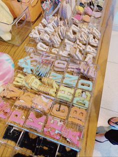 a table filled with lots of different types of cookies on top of wooden tables next to each other