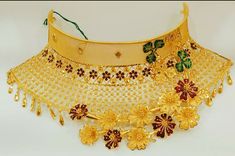 a gold necklace with flowers on it