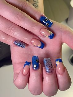 a woman's hand with blue and white nail designs on it