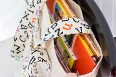 a close up of a book shelf with books and tape wrapped around the bottom half