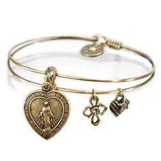 "This bangle bracelet features the Virgin Mary on a heart charm. Slide it open to reveal an inscription of the Lord's Prayer. With each bangle, transmit good vibrations and let the positive energy flow! Our bracelets are made to wear in stacks of your favorite designs. Know someone who could use an uplifting reminder to always have faith? Choice of bronze or silver. \"Our father, who art in Heaven hallowed be thy name. Thy kingdom come. Thy will be done on Earth as it is in Heaven. Give us this Blue Crystal Bracelet, Christian Bracelets, Good Vibrations, Prayer Bracelet, Lord's Prayer, The Lords Prayer, Bangle Bracelets With Charms, Energy Flow, Christian Jewelry