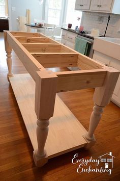 a kitchen island made out of plywood is shown in the middle of a hardwood floor