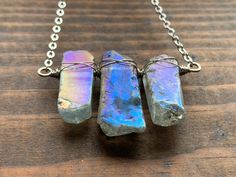 "Handmade one-of-a-kind aura quartz pendant! Catches so many rainbows in all types of light. Guaranteed to get compliments. Made with love in the US. Let us know in your order notes which specific pendant you would like based on the letters in the corner of the pictures.  If you do not let us know we will assume you wanted the pendant displayed as the first picture.  Length of chain is 16 inches standard, but we can extend it upon request free of charge (up to 20\").Pendant width is approximate, but varies based on specific piece. we hope you enjoy the happy vibes from this pendant :-)" Mystical Handmade Iridescent Necklaces, Mystical Handmade Iridescent Necklace, Mystical Iridescent Crystal Necklaces For Gift, Mystical Iridescent Crystal Necklace For Gift, Iridescent Pendant Crystal Necklace For Healing, Iridescent Crystal Necklaces For Healing, Handmade Iridescent Crystal Necklaces For Spiritual Style, Iridescent Handmade Crystal Necklace, Iridescent Handmade Healing Crystals