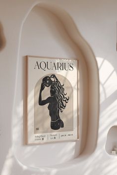 a book with an image of a woman's torso on the cover, hanging from a wall