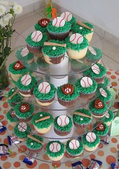 cupcakes are arranged in the shape of a christmas tree with baseballs on them