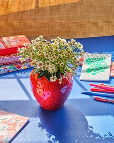 strawberry vase with white flowers on blue surface with desk accessorie scattered throughout New Yorker Loft, Giant Strawberry, Large Flower Vases, Kristina Webb, Koti Diy, Strawberry Decorations, Strawberry Fields, Keramik Vase