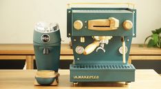 an espresso machine sitting on top of a wooden table