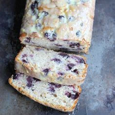 sliced loaf of blueberry bread sitting on top of a table