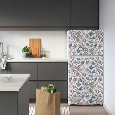 a bag sitting on top of a kitchen counter next to a sink and refrigerator freezer