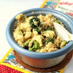 a blue bowl filled with food on top of a table