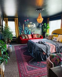 a bedroom decorated in black, red and yellow with plants on the wall behind the bed