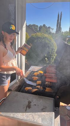 a woman cooking food on top of a grill