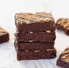 chocolate brownies with peanut butter drizzled on top, stacked up against each other