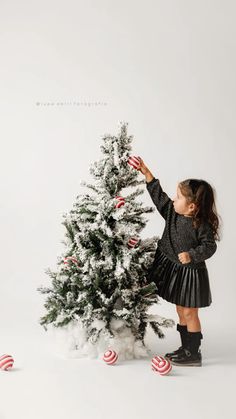 Putting her final touches on the Christmas tree! Christmas Bow Photoshoot, Kid Holiday Photoshoot Ideas, Christmas Card Toddler Photo, Christmas Picture Background Ideas, Christmas Toddler Photoshoot Ideas, Neutral Christmas Photoshoot, Simple Christmas Photoshoot Indoor, Simple Christmas Minis, Christmas Photography Set Up