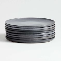 a stack of black plates sitting on top of each other