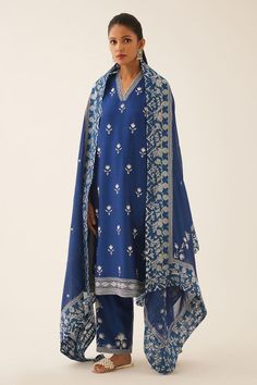 Blue straight kurta with thread embroidery in floral pattern on neckline and sleeve hem. Paired with straight pant and dupatta with floral hand block printed border on the edges.
Components: 3
Pattern: Embroidery, Hand Block Printed
Type Of Work: Thread, floral
Neckline: V neck
Sleeve Type: Three quarter
Fabric: Silk Chanderi
Color: Blue
Other Details: 
Lined kurta
Embroidery on pant hem
Elasticated waist at the back
Side pockets
Thread tassel bordered dupatta
Closure: Pant: Drawstring
Occasion: Unstitched Salwar Kameez With Embroidered Neckline, Blue Silk Kurta With Floral Embroidery, Elegant Blue Unstitched Suit With Embroidered Border, Unstitched Blue Kurta With Embroidered Border, Blue Cotton Salwar Kameez With Floral Embroidery, Traditional Blue Kurta With Embroidered Neckline, Blue Traditional Kurta With Embroidered Neckline, Blue Straight Kurta With Embroidered Border, Blue Kurta With Embroidered Border