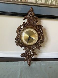 an antique clock is hanging on the wall