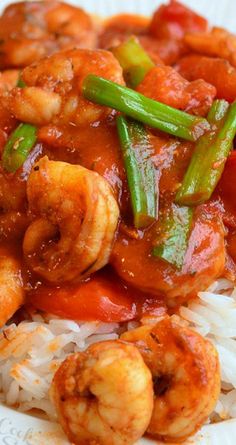 shrimp and vegetable stir fry on rice with red sauce, green beans, and onions