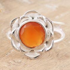 Lotus, the flower of purity, is a symbol of enlightenment for many cultures, inspiring dazzling creations around the world. Today, Indian artisans draw inspiration from this tender gift of nature to handcraft a sterling silver cocktail ring. The accessory, presented by Alok Jain, features a natural carnelian stone at the center, totaling two carats and adding a superb touch to the item. Orange Fusion Jewelry Gift, Orange Jewelry Gift, Orange Gemstone Spiritual Rings, Spiritual Faceted Ring As Gift, Spiritual Orange Gemstone Rings, Spiritual Faceted Ring For Gift, Spiritual Faceted Rings As Gifts, Spiritual Faceted Rings For Gifts, Orange Chalcedony Jewelry For Gifts