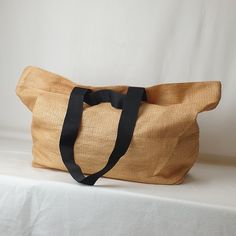 This roomy tote is perfect for almost any occassion. Fill it up with all your groceries or a weekend picnic with a blanket. Made from super lightweight recycled plastic. The fibres of this material are woven together to be dense yet super lightweight.  Complete with a strap that can be held in hand or another that is long enough for over the shoulder. The bag even has an inner zip pocket for all your essentails. DETAILS Two straps Inner zip pocket Inner sleeves Recycled Plastic DIMENSIONS H37 x W57 x D15cm Eco-friendly Lightweight Beach Bag, Casual Reusable Bags From Recycled Plastic Bottles, Casual Reusable Bags Made From Recycled Plastic, Eco-friendly Large Capacity Beach Bag, Eco-friendly Rectangular Beach Bag, Everyday Natural Reusable Bag, Natural Color Reusable Everyday Bag, Summer Travel Bags Made Of Recycled Materials, Casual Reusable Bags Made Of Recycled Materials