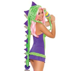 a woman dressed in a costume with pink hair and green dragon headdress is posing for the camera