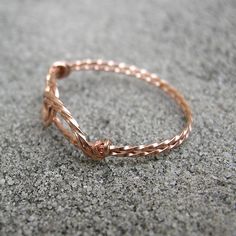 A fun and unique wirewrapped thumb ring made from twisted 14kt rose gold filled wire. The two interlocked swirls form a sort of infinity design, and the wire lays flat against your skin. Rose gold, or pink gold, is very fashionable these days! And I make this ring in a variety of sizes to fit everyone, no matter how big or small your finger may be! Modern Twist Wire Wrapped Rings For Gifts, Modern Twist Wire Wrapped Rings As Gift, Wire Wrapped Rings As A Modern Gift, Rose Gold Hand Wrapped Ring As Gift, Hand Wrapped Rose Gold Ring Gift, Adjustable Rose Gold Wire Wrapped Ring, Adjustable Wire Wrapped Rose Gold Ring, Wire Wrapped Rose Gold Rings, Minimalist Wire Wrapped Rose Gold Ring