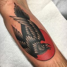 a black and red tattoo with an eagle on it