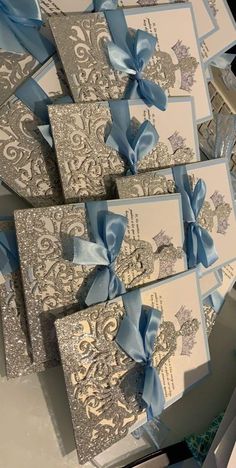 several cards with blue bows are stacked on top of each other in an intricate pattern