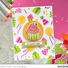 a handmade birthday card with a cupcake on it and balloons in the background