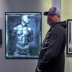 a man standing in front of a painting