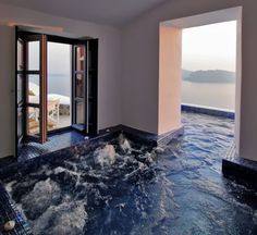 an indoor jacuzzi is shown with open doors