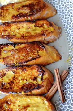 grilled french toast on a plate with cinnamon sticks