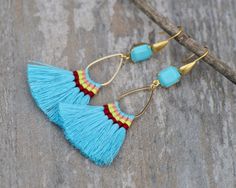 "Gorgeous new earrings made using hand made cotton tassels and vintage Swarovski crystal. The earrings are made with octagon shaped crystals that are opaque turquoise blue, set into gold plated settings. They hang from matte gold french ear wires with teardrop detail. Crystals connect to hand made cotton tassels, with colorful hand wrapped thread detail. Total earring length is 3\". For reference, tassels alone are 2\" long." Blue Tassel Earrings, Shaped Crystals, Blue Tassel, Earring Gold, Vintage Turquoise, Trendy Gift, Gold Earrings Dangle, Earrings Vintage, Matte Gold