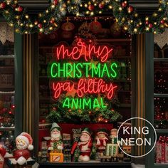 a christmas display with lights and decorations in front of a window that says merry christmas you're birthday animal