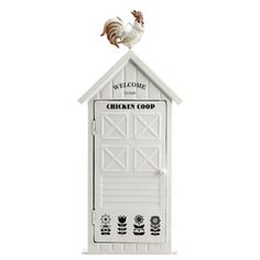 a chicken is perched on top of a small white house with the words chicken coop painted on it